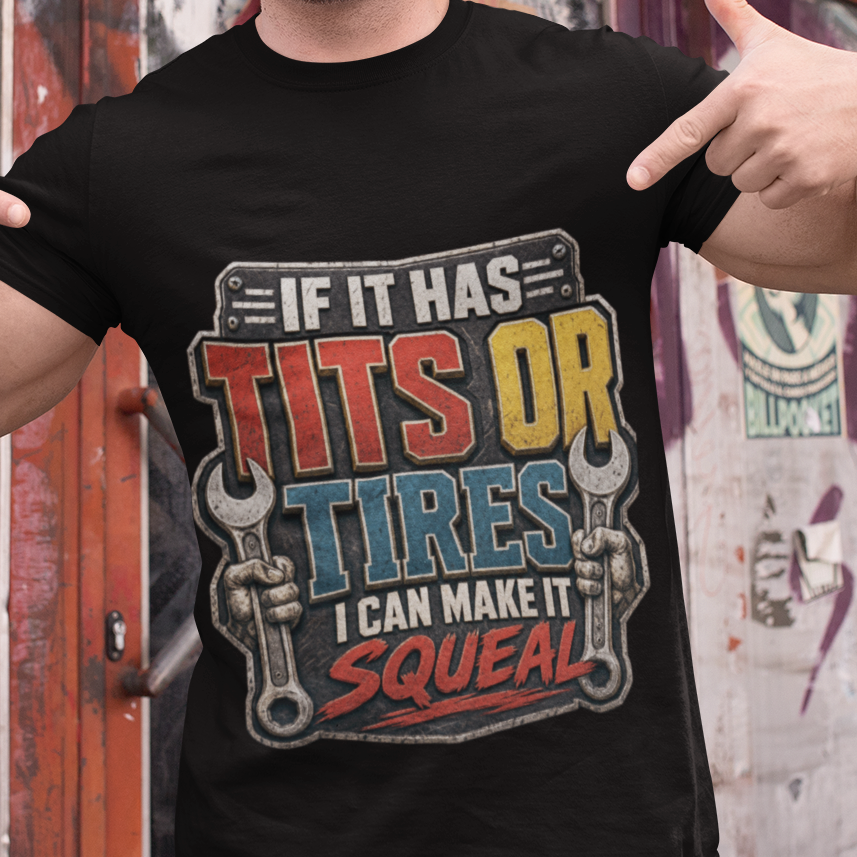 A man wearing a black graphic t-shirt with the text 'IF IT HAS TITS OR TIRES I CAN MAKE IT SQUEAL' in colorful lettering, posing in front of a graffiti-covered wall.